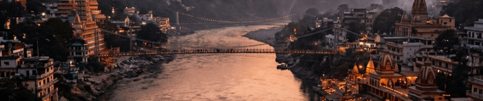 Ganges River flowing between mountain temples illuminated at dusk