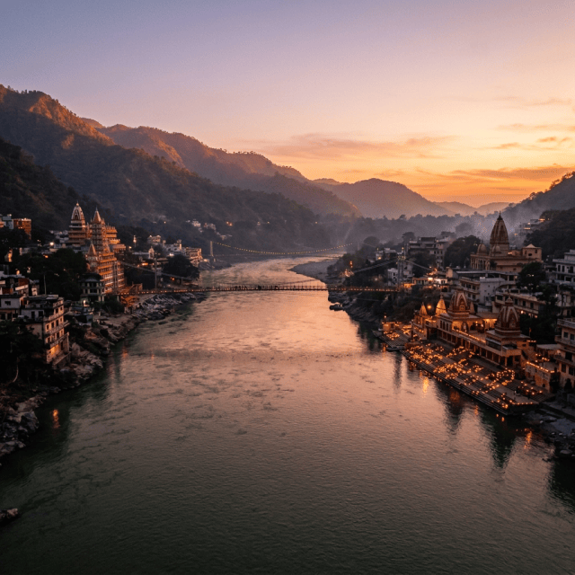 Ganges River flowing between mountain temples illuminated at dusk